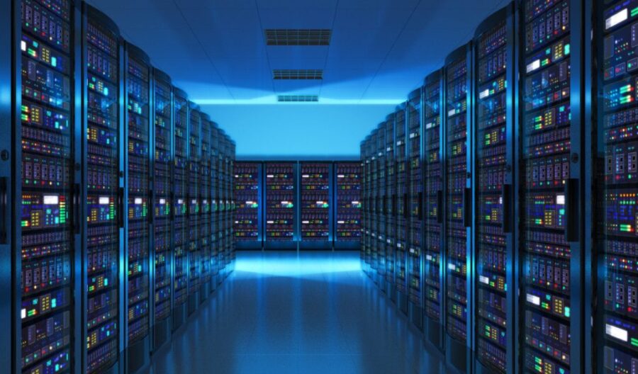 A vast server room with rows of glowing computer racks stretches into the distance, illuminated by cool blue lighting.