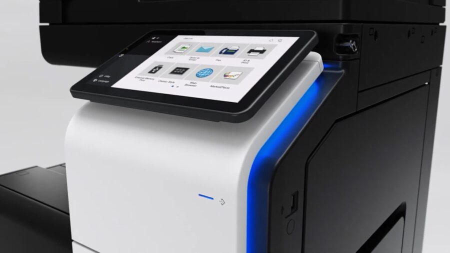 A modern black and white printer features a touchscreen display with various function icons.