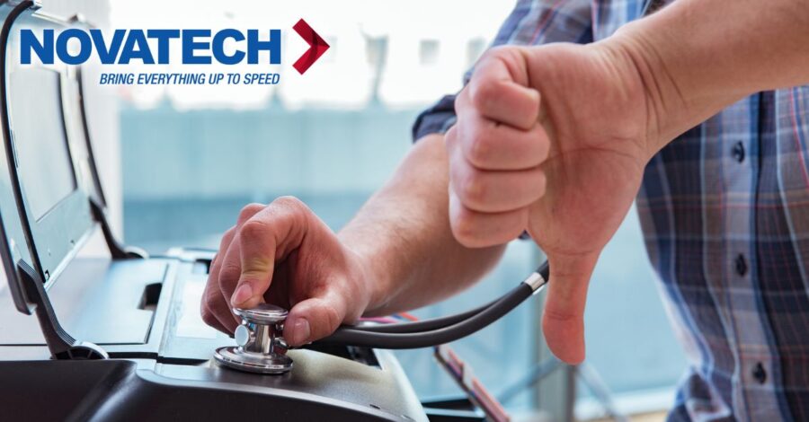A person gives a thumbs down while using a stethoscope to examine a piece of office equipment, with the Novatech logo