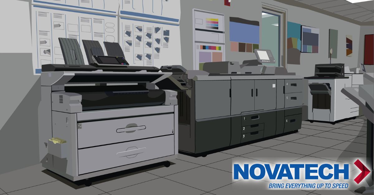 A modern office space features multiple large printing and copying machines, along with a logo for 