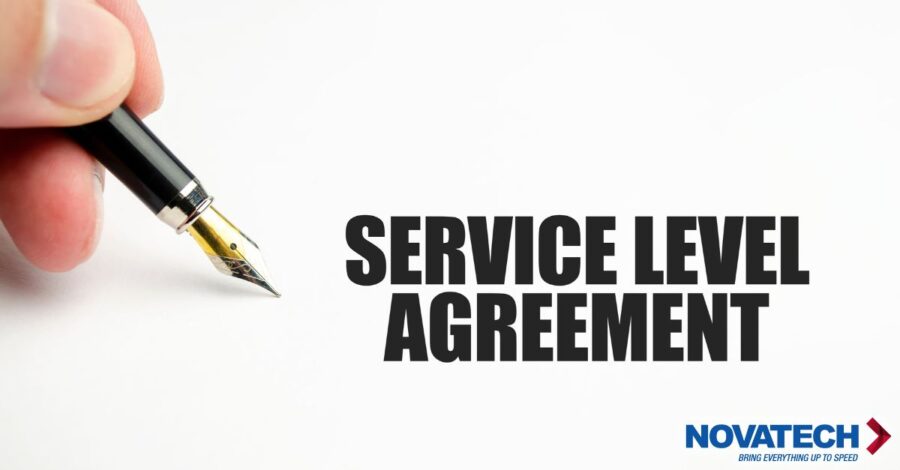 A hand holds a fountain pen over a white surface, with the words 