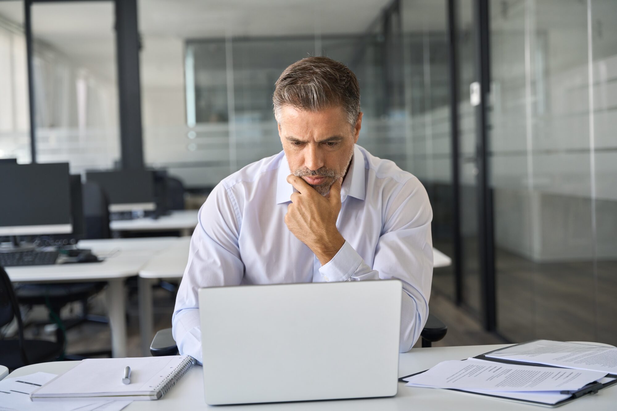 A focused man with a thoughtful expression works